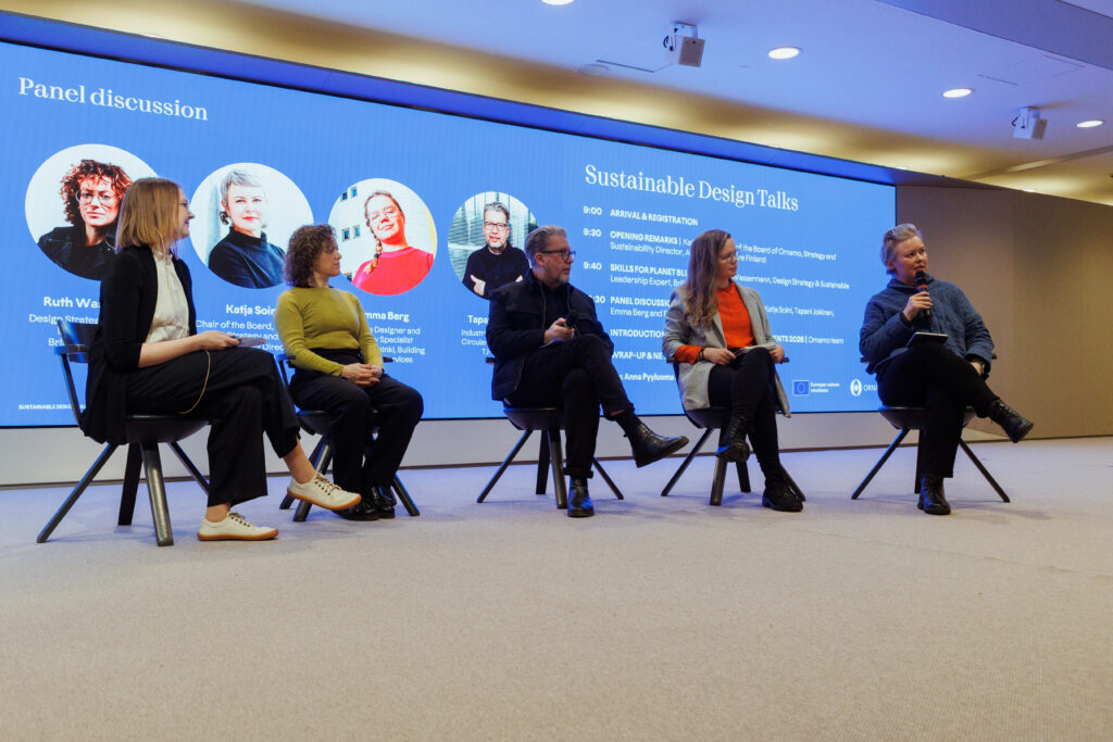 Panel discussion at Sustainable Design Talks at Helsinki City Hall, with Anna Pyyluoma, Ruth Wassermann, Tapani Jokinen, Emma Berg, and Katja Soini discussing sustainable design on stage.